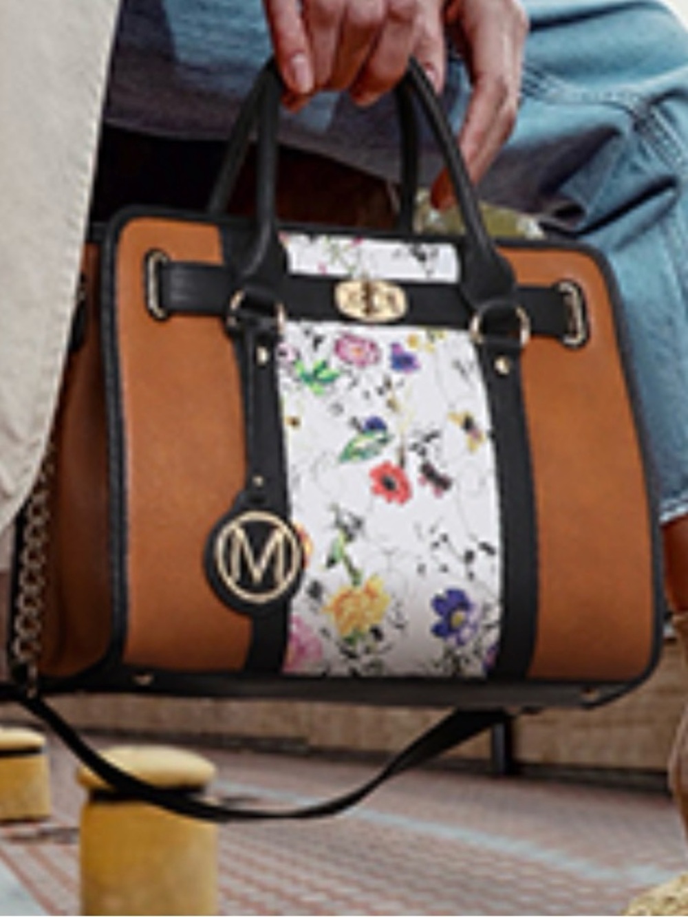 Marco M Kelly Two Tone Vegan Leather Satchel features a distinct floral panel